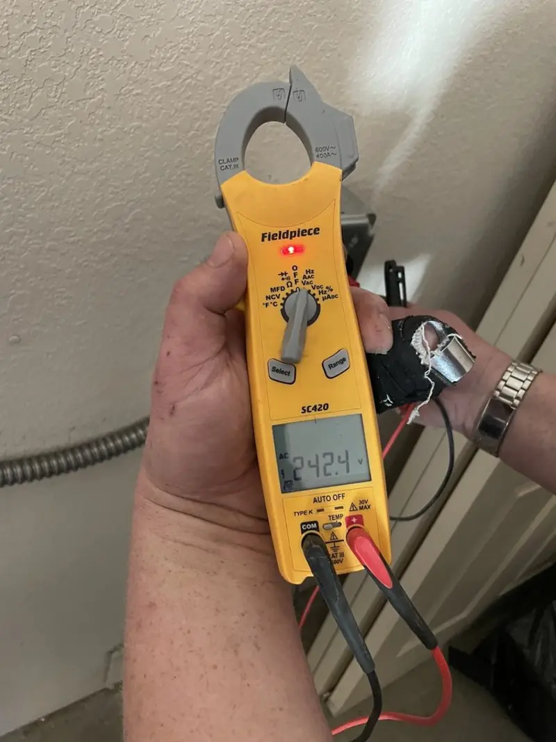 Voltage testing with clamp meter during Recessed Lighting Installation in Arbuckle
